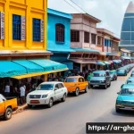 Home 22 가나의 도시별 특징 아크라 쿠마시 타말레 등 - A vibrant urban street scene in Accra, Ghana, showcasing a dynamic blend of towering modern skyscrap...